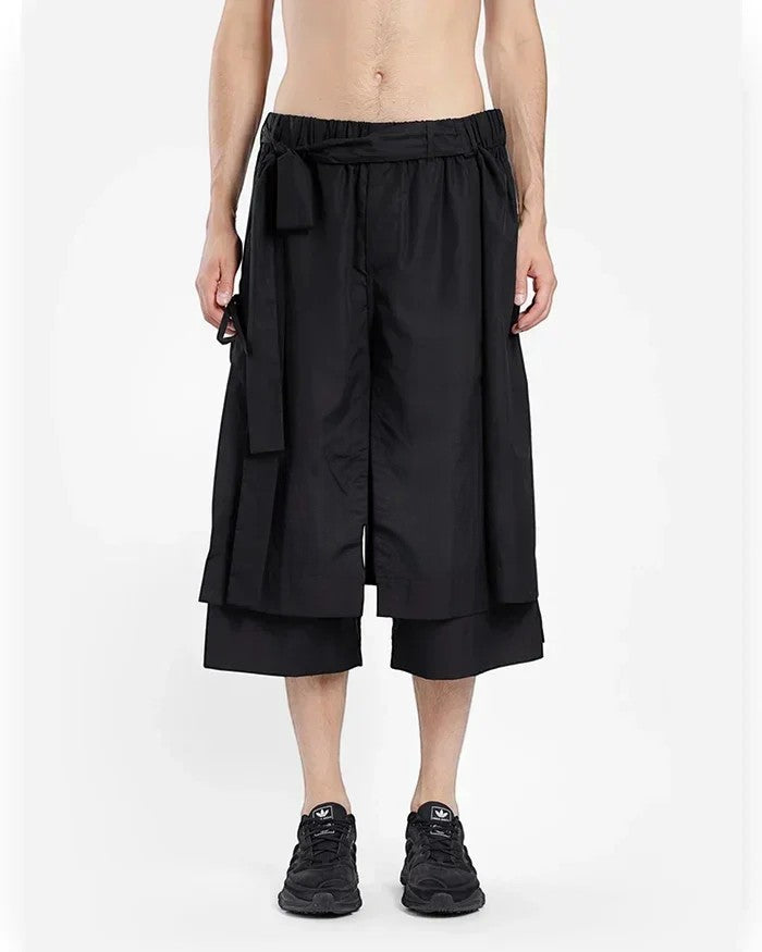 Clotechnow black short-length hakama pants with a wide-leg draped silhouette and an integrated waist tie belt.