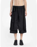 Clotechnow black short-length hakama pants with a wide-leg draped silhouette and an integrated waist tie belt.