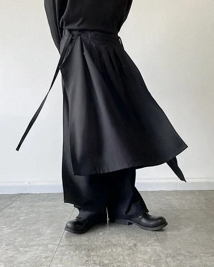 Clotechnow black modular skirted hakama pants featuring a layered hybrid silhouette and tie-waist detail
