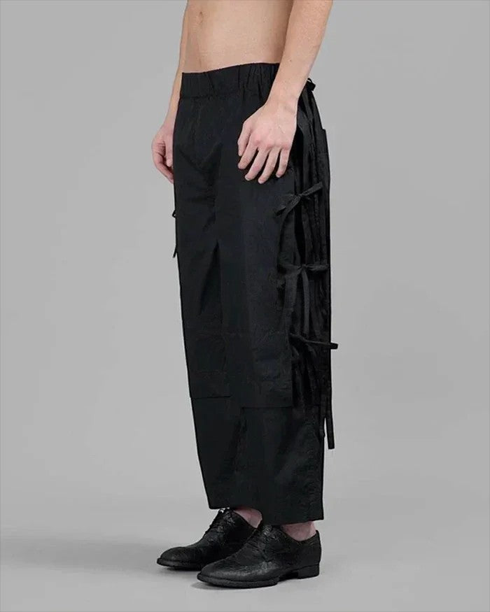 Clotechnow black taper cuff hakama pants with side tie details and wide-leg silhouette worn by a model