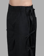 Clotechnow black taper cuff hakama pants featuring a wide-leg silhouette and side tie-up detail