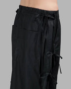 Clotechnow black taper cuff hakama pants featuring a wide-leg draped silhouette and adjustable side tie details.