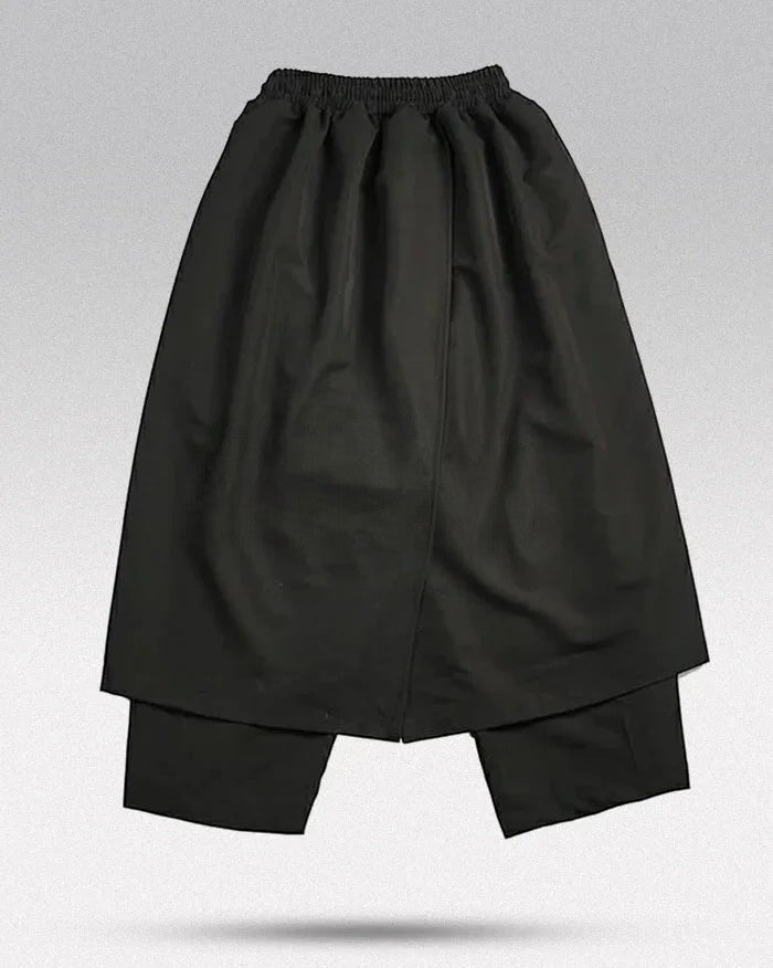 Clotechnow black Tattsuke hakama pants featuring a wide-leg draped silhouette and elasticated waist.
