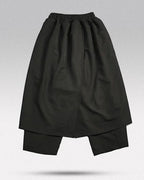 Clotechnow black Tattsuke hakama pants featuring a wide-leg draped silhouette and elasticated waist.