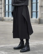 Clotechnow black Tattsuke hakama pants with a wide-leg draped silhouette worn with black lace-up boots