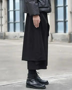Clotechnow black Tattsuke profile hakama pants with a wide-leg draped silhouette worn with black leather boots.