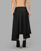 Clotechnow black wide-leg Night Utility Hakama pants with a draped silhouette and layered design, back view.
