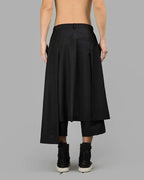 Back view of Clotechnow Night Utility Hakama Pants in black with a wide-leg draped silhouette and layered design.
