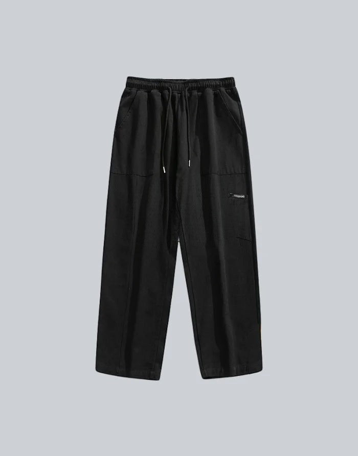 Clotechnow black wide-leg hakama pants with an elastic drawstring waist and minimalist streetwear design.