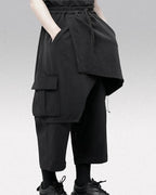 Clotechnow black wide-leg hakama pants featuring a draped layered silhouette, side cargo pockets, and drawstring waist.