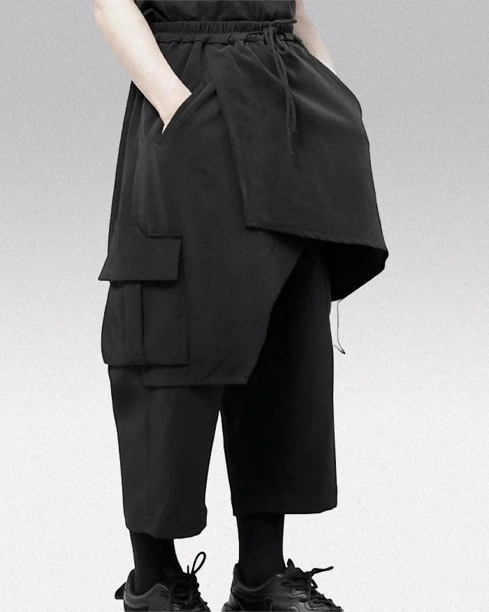 Clotechnow black wide-leg hakama pants featuring a draped layered silhouette, side cargo pockets, and drawstring waist.