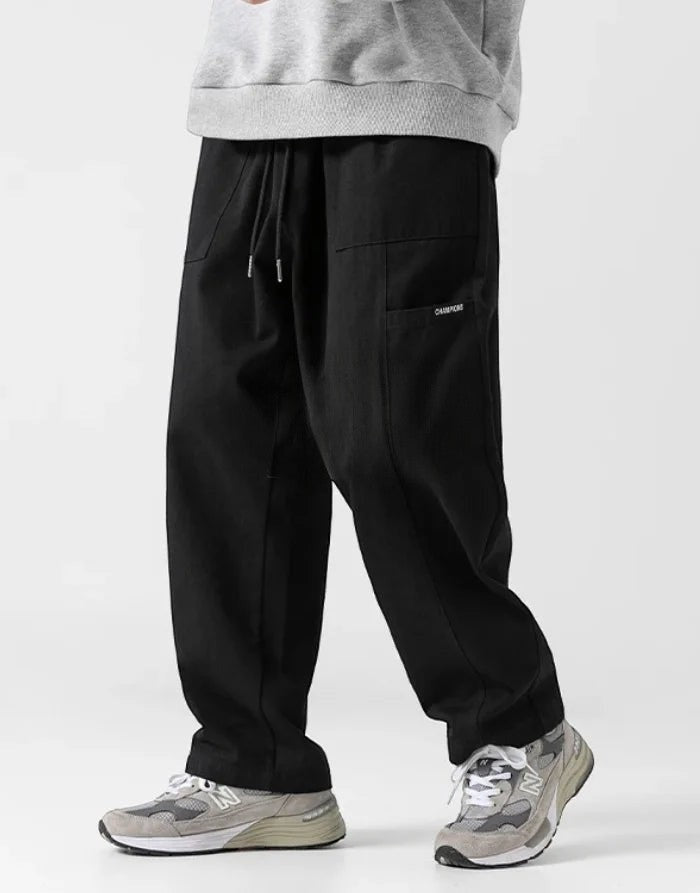 Black wide-leg hakama pants with side pocket detail styled with a grey sweatshirt
