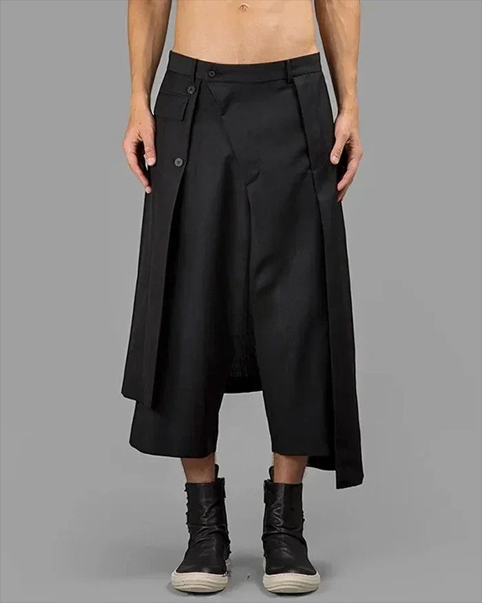 Clotechnow black wide-leg hakama pants with a layered wrap design and button closure worn with dark boots