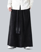 Clotechnow black wide-leg hakama pants with vertical texture and embroidered detail on the front panel