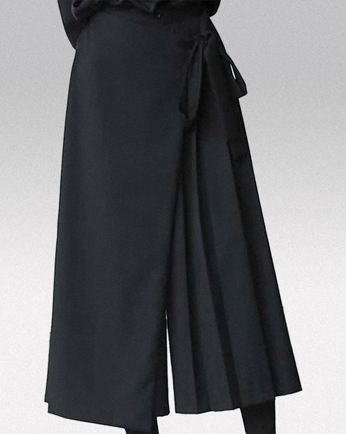 Clotechnow black wide-leg hakama pants with a wrap-around tie waist and pleated draped silhouette.