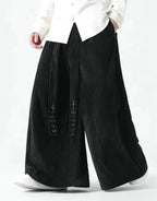 Clotechnow black wide-leg Harajuku hakama pants with vertical texture and draped silhouette on a model