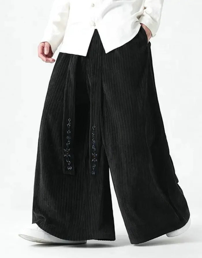 Clotechnow black wide-leg Harajuku hakama pants with vertical texture and decorative embroidery on the front panel.