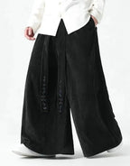 Clotechnow black wide-leg Harajuku hakama pants with vertical texture and decorative embroidery on the front panel.