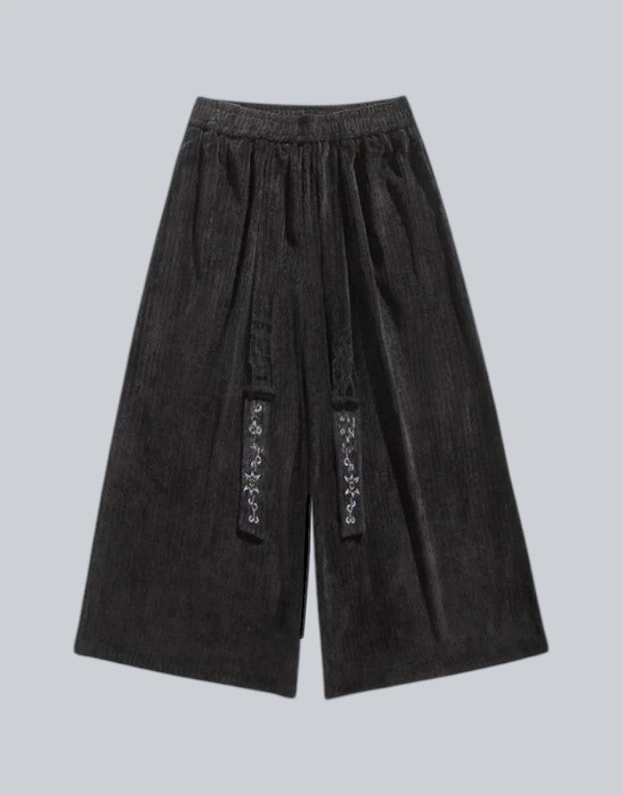 Clotechnow black wide-leg Harajuku hakama pants with textured fabric and decorative embroidered front detailing.