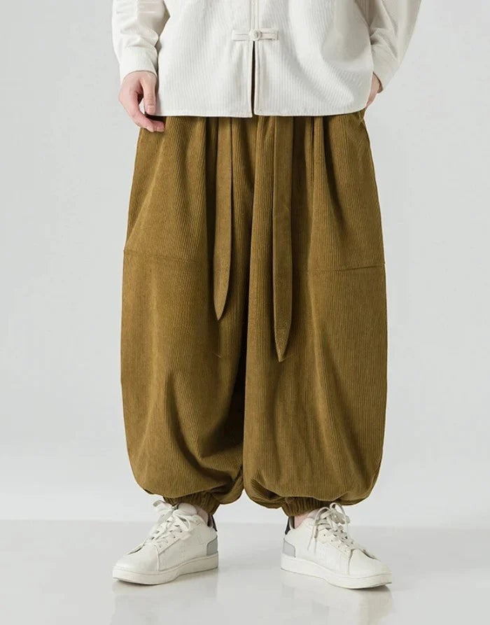Clotechnow brown corduroy hakama pants with a ribbon tie waist and wide-leg draped silhouette on a model