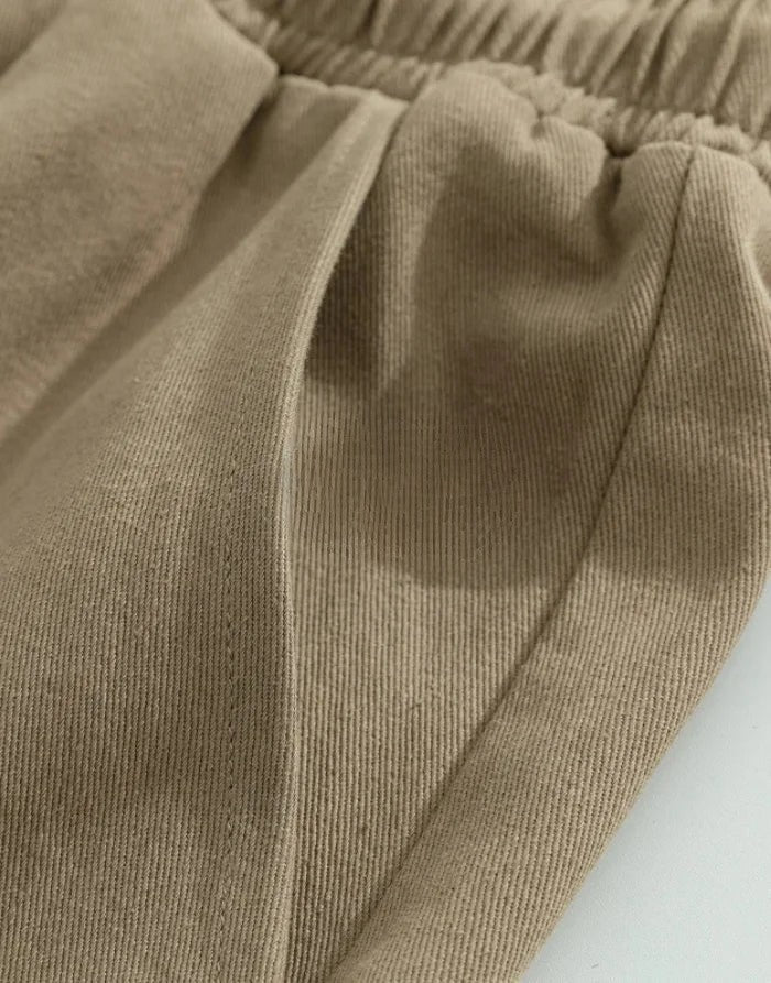 Close-up of brown Clotechnow Plush Layer Hakama Pants showing the textured fabric and deep side pocket detail.