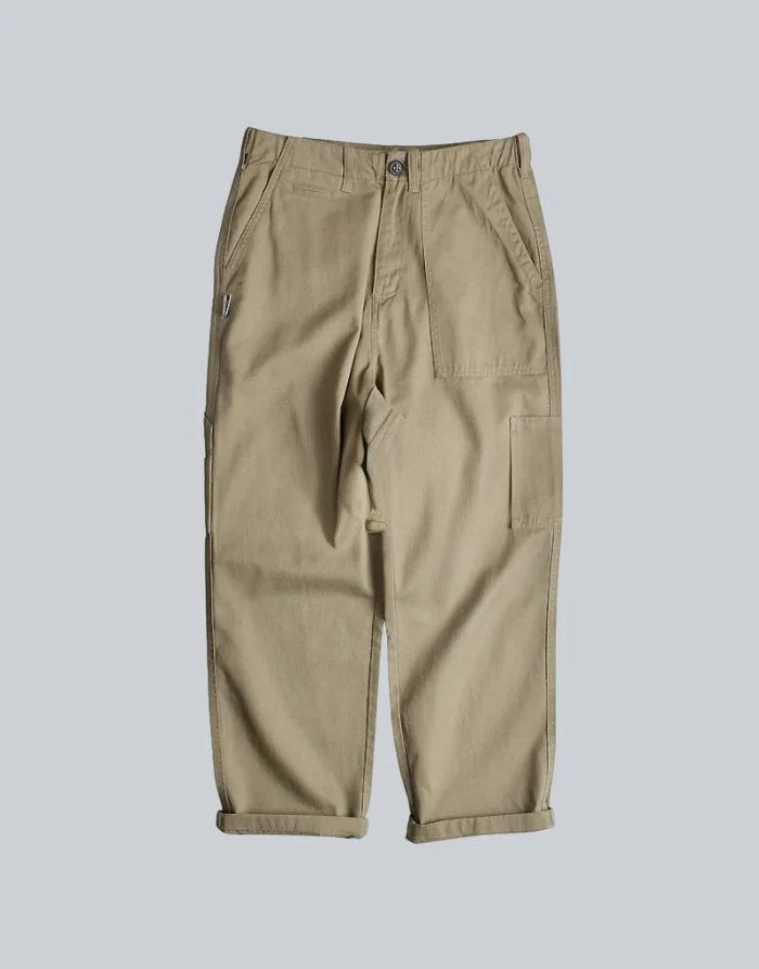 Clotechnow multi-utility hakama pants in beige with a wide-leg silhouette, side pockets, and a button-fly closure.