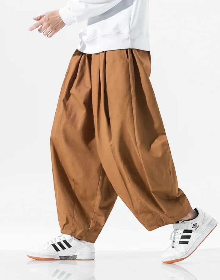 Clotechnow brown wide-leg hakama pants with a draped silhouette worn with white sneakers on a model