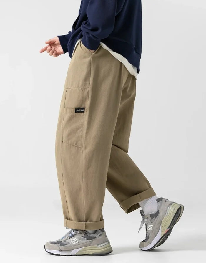 Clotechnow brown wide-leg hakama pants with a relaxed fit, side pockets, and cuffed hems worn with grey sneakers.