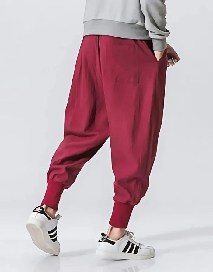 Clotechnow Crimson Fold Hakama Pants featuring a wide-leg draped silhouette with cuffed ankles in deep red fabric.