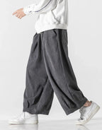 Clotechnow dark grey cord texture hakama pants with a wide-leg draped silhouette worn with white sneakers