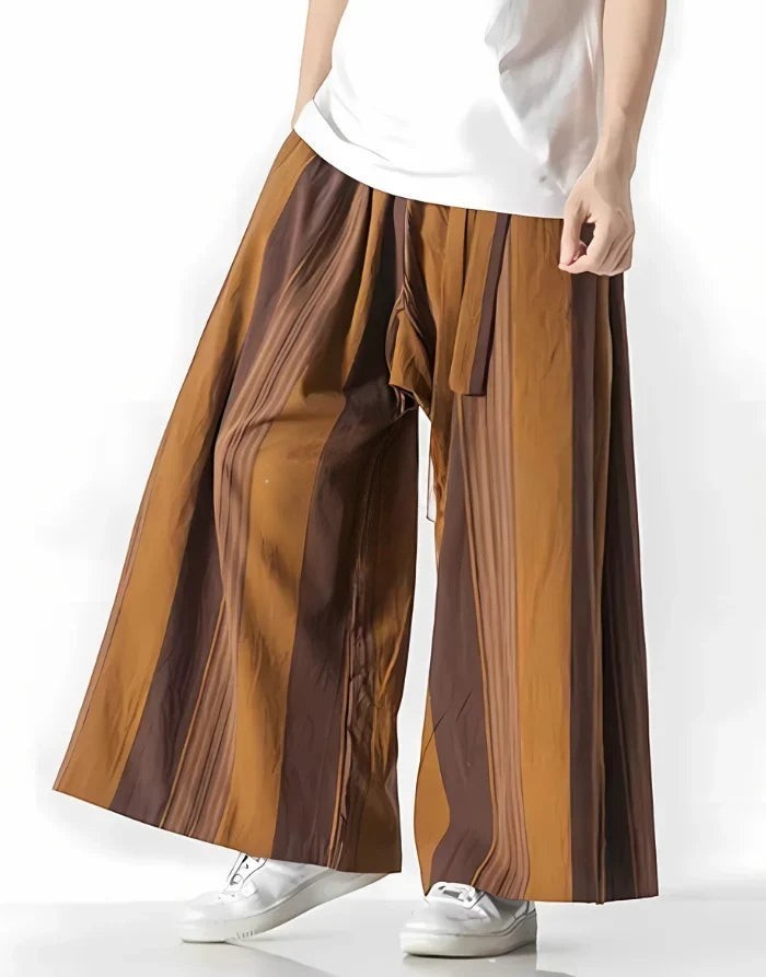 Clotechnow earth tone striped hakama pants with a wide-leg draped silhouette worn with a white t-shirt