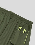 Clotechnow forest green wide-leg hakama pants featuring an elastic waistband and lime green pocket detailing.