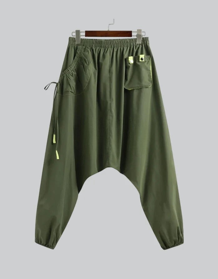 Clotechnow forest green wide-leg hakama pants with a drop crotch, elastic waist, and utility pocket details.