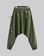 Clotechnow forest green wide-leg hakama pants with a drop crotch, elastic waist, and utility pocket details.