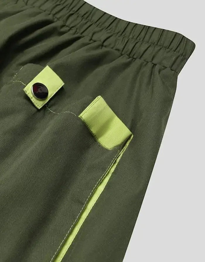 Clotechnow forest green hakama pants featuring lime green pocket accents and black button details