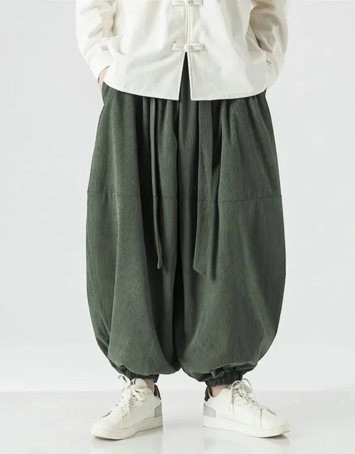 Clotechnow green corduroy hakama pants with a wide-leg draped silhouette and ribbon tie waist detail