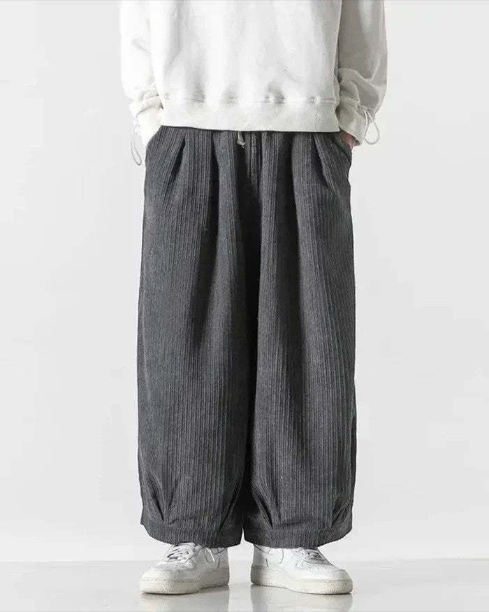 Clotechnow grey wide-leg hakama pants with a textured vertical stripe pattern and a relaxed draped silhouette.