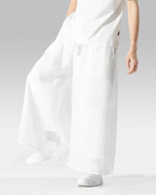 Clotechnow Ivory Flow Hakama Pants featuring a wide-leg silhouette in white, styled with a matching white top.