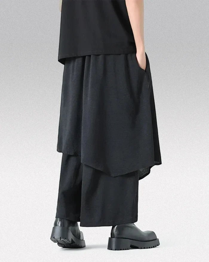 Clotechnow Monochrome Divide black wide-leg hakama pants with layered draped fabric and a modern streetwear silhouette.