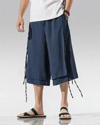 Clotechnow navy blue wide-leg sarouelle hakama pants with draped layered design and side tie details