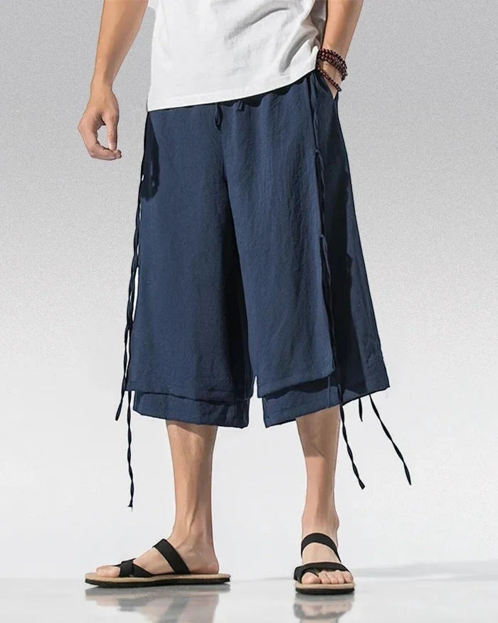 Clotechnow navy blue wide-leg sarouelle hakama pants with draped layered design and side tie details