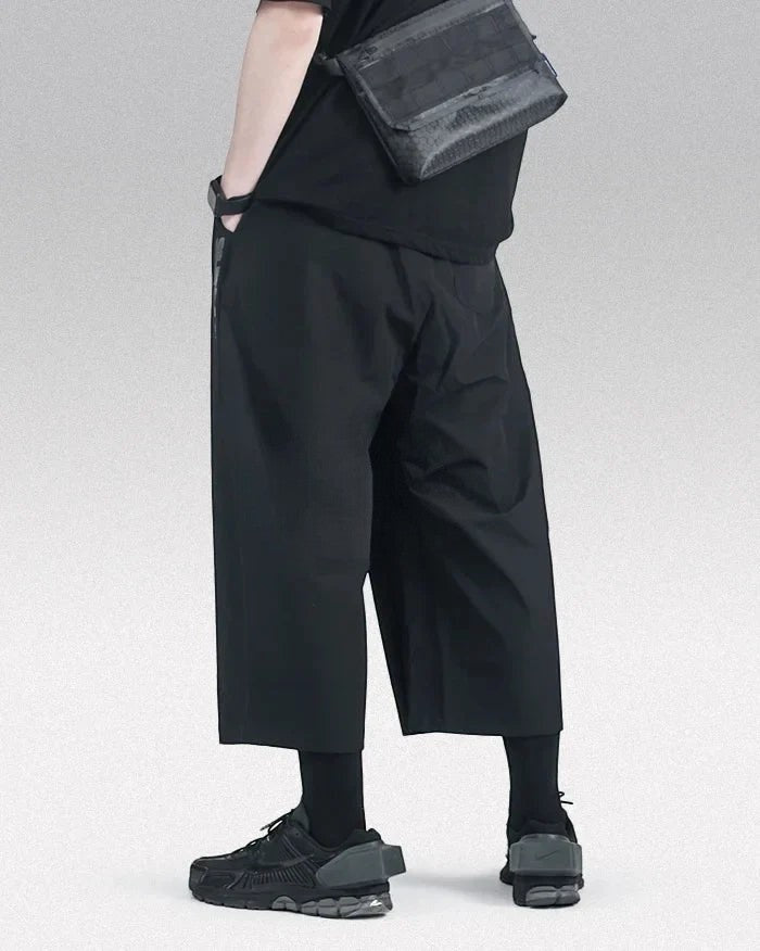Clotechnow Ninja Motion black wide-leg hakama pants with a draped silhouette worn with techwear sneakers