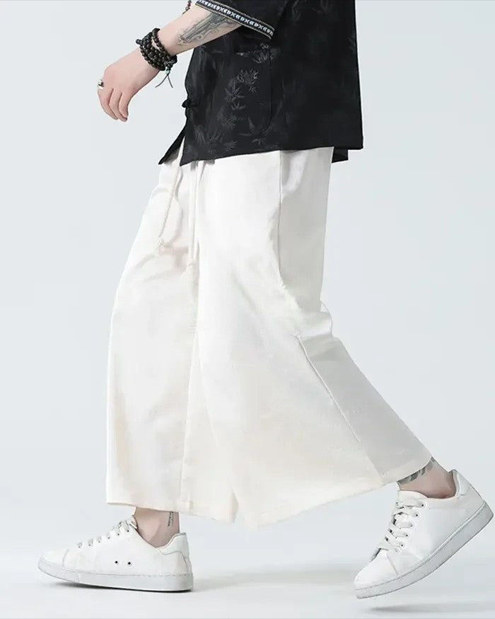 Clotechnow pale modern hakama pants with a wide-leg silhouette and drawstring waist worn with white sneakers