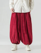 Clotechnow red corduroy hakama pants with a wide-leg draped silhouette and ribbon tie waist detail