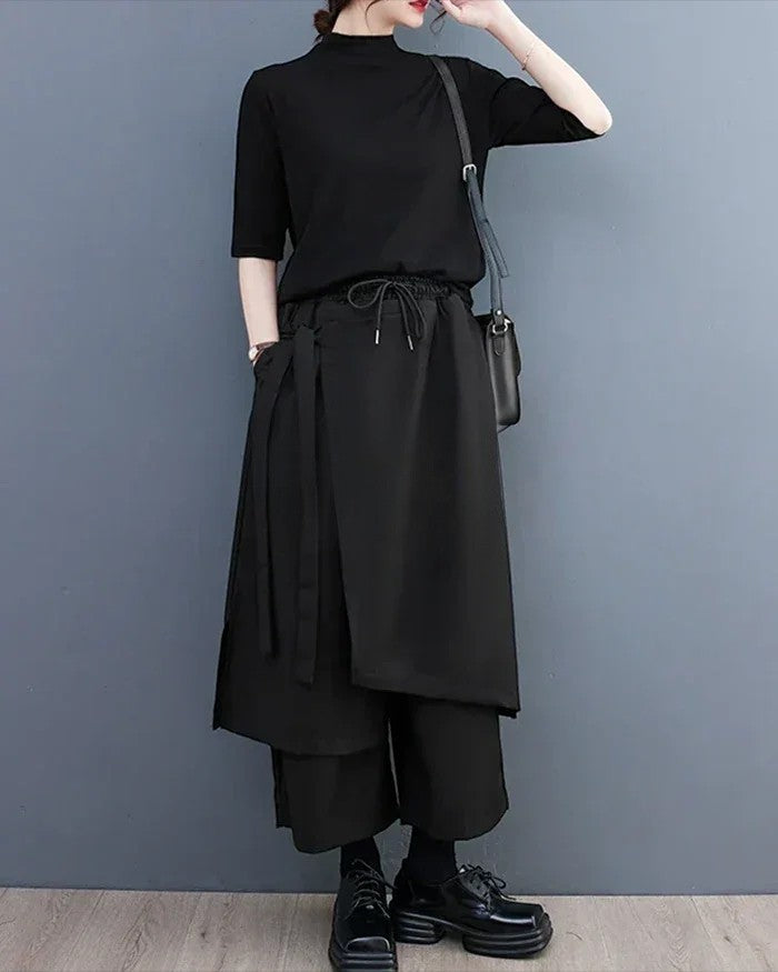 Clotechnow sculpted black hakama pants with a wide-leg draped silhouette and drawstring waist on a model