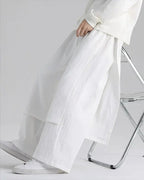 Clotechnow white lightweight drape hakama pants with a wide-leg silhouette worn by a person sitting on a chair