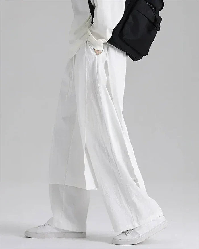 Clotechnow lightweight white wide-leg hakama pants with a draped silhouette worn with white sneakers