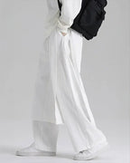 Clotechnow lightweight white wide-leg hakama pants with a draped silhouette worn with white sneakers