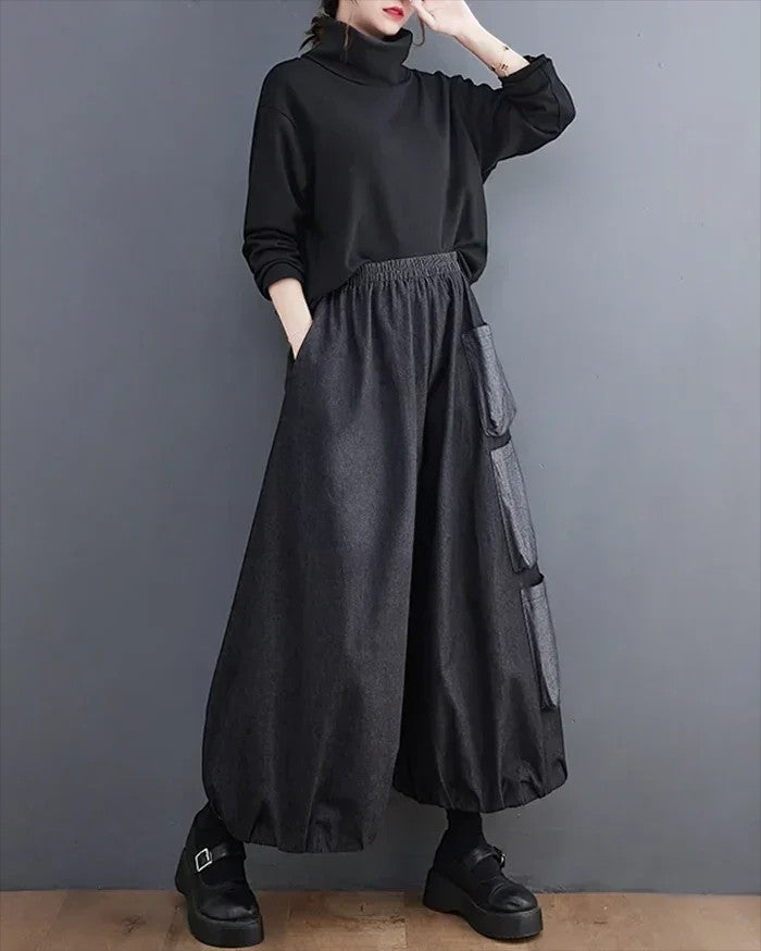 Clotechnow Modern Muse wide-leg hakama pants in charcoal grey with side pockets worn by a model in a black turtleneck