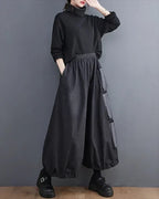 Clotechnow Modern Muse wide-leg hakama pants in charcoal grey with side pockets worn by a model in a black turtleneck